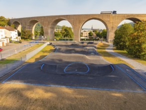 Pump track with asphalt under a large bridge in a green environment, pump track, Nagold, Black