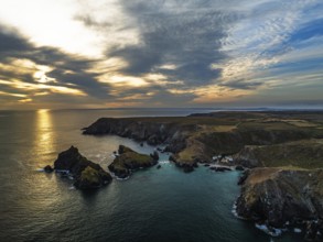 Sunset over Kynance Cove from a drone, Mount's Bay, Lizard Point, Cornwall, England, United Kingdom