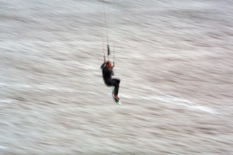 Kitesurfer jumping in the surf, wiping effect, long exposure, Sankt Peter-Ording, Eiderstedt