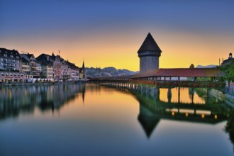 Chapel bridge with water tower reflected in the river Reuss, Lucerne old town at dawn, Canton