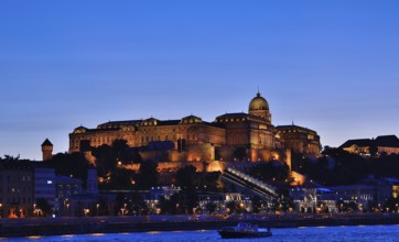 Buda castle, a historic landmark in budapest, hungary, is illuminated against the twilight sky,