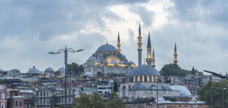 Majestic suleymaniye mosque glowing under cloudy sky at dusk, showcasing istanbul's rich history