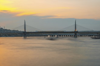 Long exposure of a metro train crossing the golden horn metro bridge in istanbul, turkey, during a