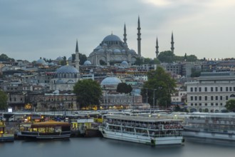 Suleymaniye mosque at dusk, with ferry boats navigating the golden horn, creates a captivating view