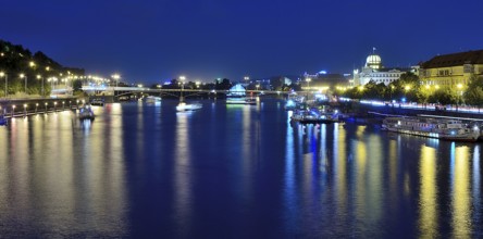 Vltava river reflecting the vibrant cityscape of prague, with boats sailing gracefully on a warm