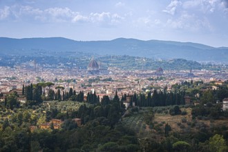 Sweeping views of the city of Florence and cathedral surrounded by Tuscan hills in Italy
