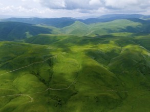 Green hills stretch under a cloudy sky, picturesque landscape, aerial view, Dilijan National Park,