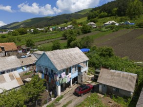 Village with traditional houses, colourful clothes on the washing line, rural idyll with mountains