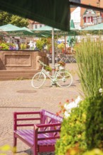 A sunny square with a decorative bicycle and flowers, small town pearl Calw, Black Forest, Germany