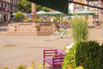 A lively square with a decorated bicycle and blooming fountain, small town pearl Calw, Black