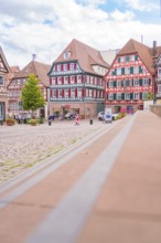 View of a picturesque market square with half-timbered houses in historical style, small town of
