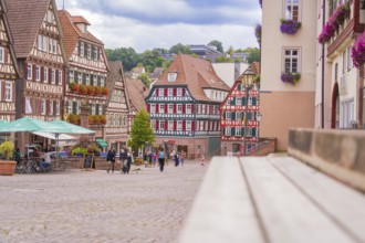 Lively street scene with half-timbered houses and passers-by, small town of Perle Calw, Black