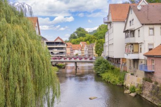 Bridge over a river with hanging willows and neighbouring town buildings, small town of Perle Calw,