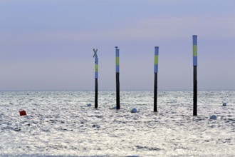 Four poles in a row, marker, sea mark, buoys, evening sky, Sankt Peter-Ording, Eiderstedt