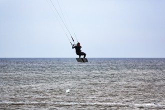 Kitesurfer jumping, Sankt Peter-Ording, Eiderstedt peninsula, Wadden Sea National Park, North Sea,