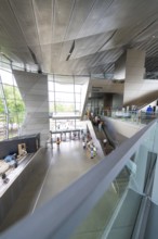 Large modern interior with visitors and striking architectural elements, BMW Welt, Munich, Germany