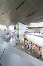 Modern building complex with various shops and numerous visitors, BMW Welt, Munich, Germany