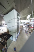 View from above of an exhibition space with many visitors and modern elements, BMW Welt, Munich,