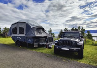 Car with tent trailer at the campsite in Vopnafjördur, East Iceland, Iceland