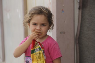 A Syrian refugee child photographed in a camp, reflecting the harsh living conditions of displaced