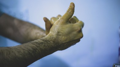 A doctor washing his hands before entering the operating room to perform surgery. Aleppo, Syria