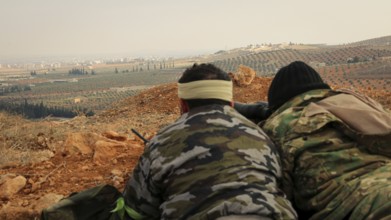 Syrian opposition fighters planning military strategies in preparation for clashes with ISIS.