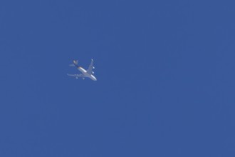 Boeing 747 jumbo jet cargo aircraft of UPS United Postal Service flying in a blue sky, England,