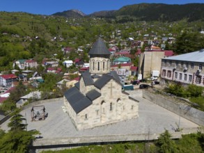 Church in a small mountain village with traditional architecture and green, picturesque