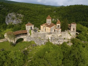 Spacious monastery structure on a rock surrounded by forest landscape, aerial view, Motsameta
