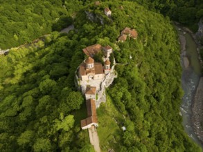 Aerial view of a monastery in the middle of a green forest, near a river, aerial view, Motsameta