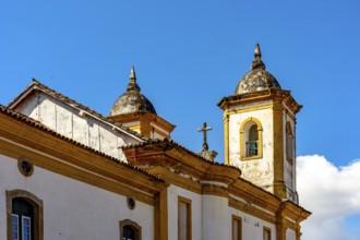 Towers and roof of a historic baroque church in the old city of Ouro Preto