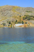 View of the ocean and monastery in the distance from Nimborio Beach, Nimborio, Symi Island,