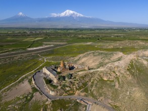 Historical monastery in mountain landscape with blue sky and wide nature, aerial view, monastery