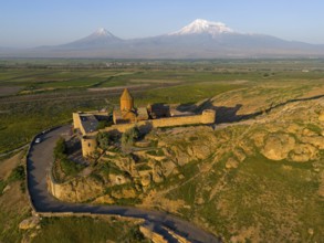 Historic fortress in hilly landscape with mountains in the background, aerial view, Chor Wirap