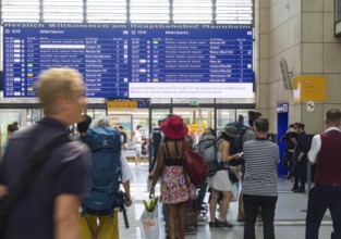 Mannheim main station, interior view with people and display board. Mannheim, Baden-Württemberg,
