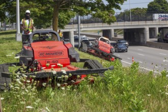 Harper Woods, Michigan - Remote-control mowers are cutting the grass and weeds along Interstate 94