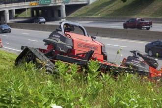 Harper Woods, Michigan, Remote-control mowers are cutting the grass and weeds along Interstate 94