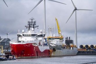 Working vessels in the seaport of Eemshaven, dredger Vitus Bering, aft, cable layer and offshore