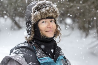 Woman enjoying a cold weather, Woman smiling under a snowfall, Gaspesie national park, Province of