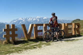 Mountain biker looks from the photo spot 'Verbier' on the Col de la Croix de Cœur pass to the
