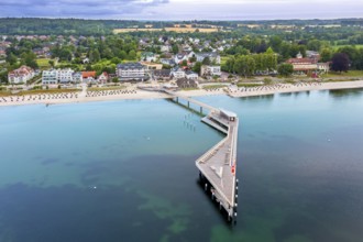 Aerial view over Seebrücke, pier and sandy beach at seaside resort Haffkrug along the Baltic Sea,