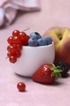 Various fruits in peel, redcurrant, peach, strawberry, blueberry, blackberry