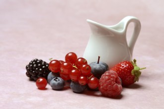Various fruits with jug, redcurrant, raspberry, strawberry, blueberry, blackberry