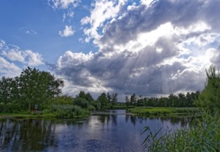 Sun and clouds over the River Trave in Brenner Moor. The Brenner Moor is a salt moor, FFH area, in