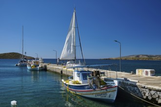 Boats are moored along a pier on the calm blue water, Analipsi, Maltezana, Astypalea, Astipalea,