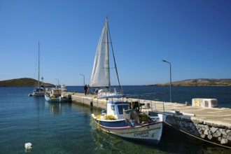 Two boats are moored at a pier, a sailing boat sails past, Analipsi, Maltezana, Astypalea,