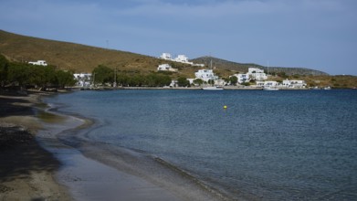 A secluded beach overlooking a coastal settlement and the calm sea, Analipsi, Maltezana, Astypalea,