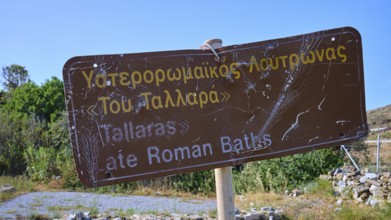 A weathered sign points to the ancient Roman baths, Analipsi, Maltezana, Astypalea, Astipalea,