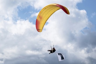 Paragliding tandem flight with Baselstadt flag, Interlaken, Switzerland