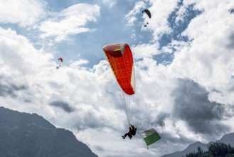 Paragliding tandem flight canton Vaud flag, Interlaken, Switzerland